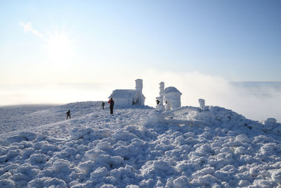 Scenic view of snow covered buildings against sky