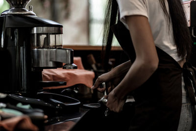 Midsection of woman working in kitchen