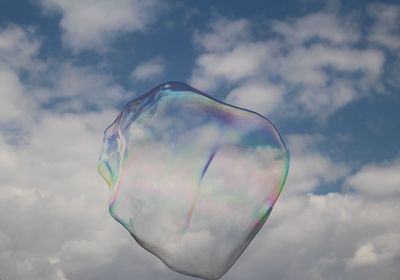 Low angle view of bubbles against sky