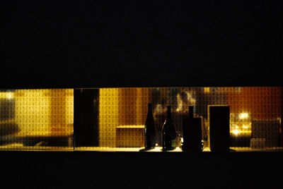 Men standing in illuminated room