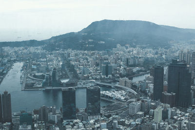 High angle view of city buildings against sky