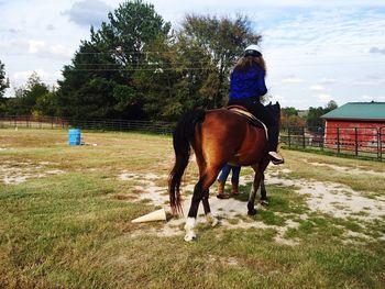 Woman horse riding at ranch