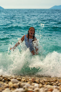 Girl splashing water in sea