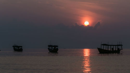 Koh rong island, cambodia at sunrise. strong vibrant colors, boats and ocean