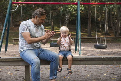 Father playing with son on playground