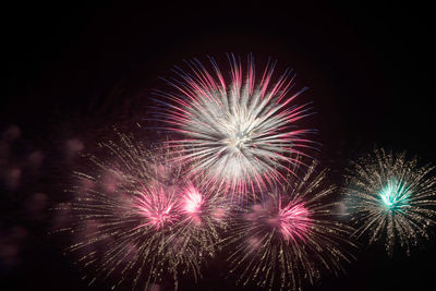 Low angle view of firework display at night