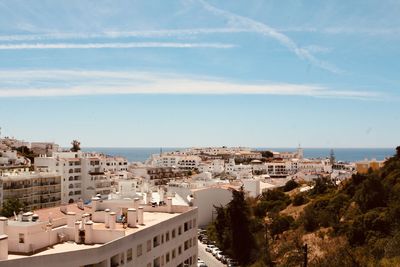 High angle view of townscape by sea against sky