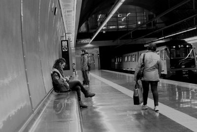 Full length of woman standing by railing