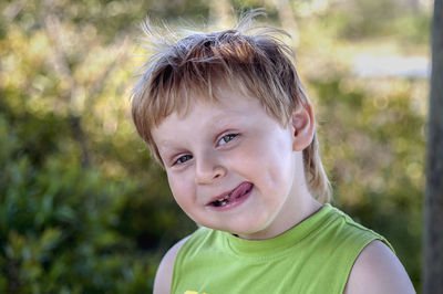 Close-up portrait of boy sticking out tongue