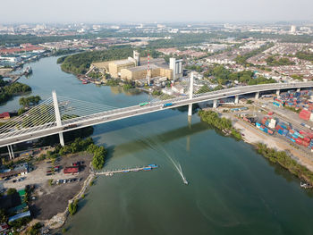 High angle view of bridge over river amidst buildings in city