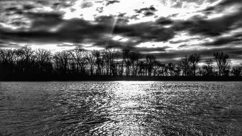 Scenic view of lake against cloudy sky