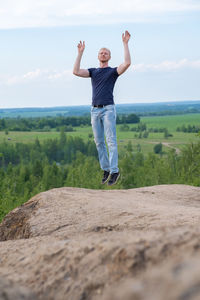 Full length of woman standing on rock