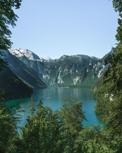 Scenic view of lake and mountains against clear sky