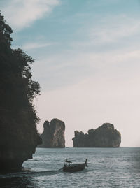 Scenic view of rocks in sea against sky