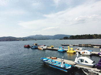 Boats moored in sea against sky