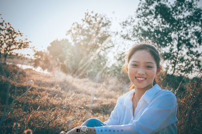 Portrait of smiling young woman on field