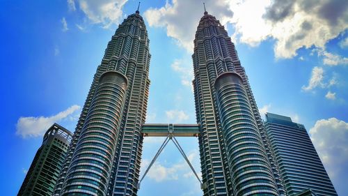 Low angle view of buildings against cloudy sky