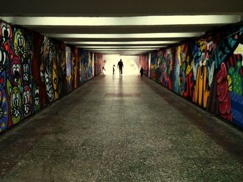 Rear view of man walking in subway