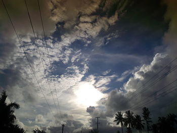 Low angle view of silhouette trees against sky