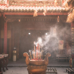 Man on illuminated temple against building