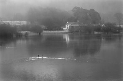 Scenic view of calm lake against sky during sunset