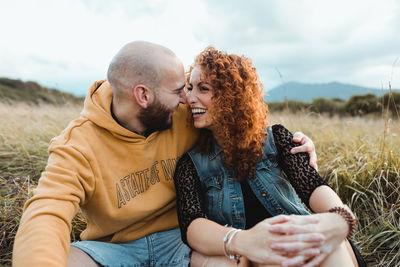 Midsection of couple holding hands