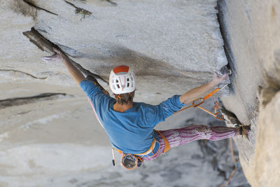 Rock climber crack climbing on the nose, el capitan in yosemite