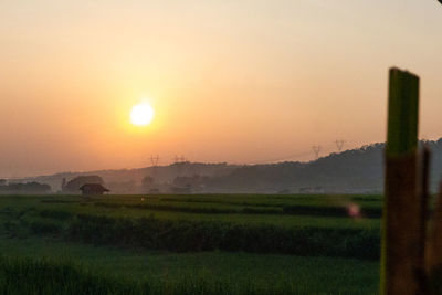 Scenic view of field against sky during sunset