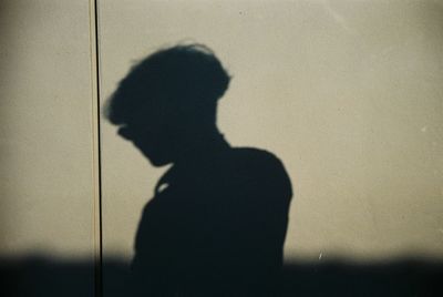 Silhouette of man on wall