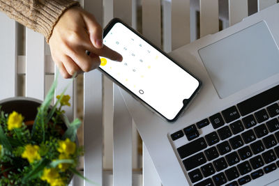 Hand using mobile calculator in the office.