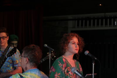 Woman by microphone at concert