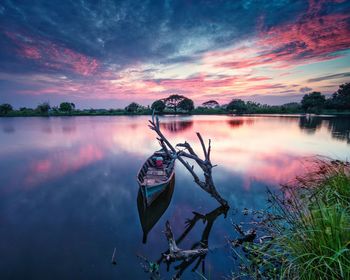 Scenic view of lake against sky at sunset