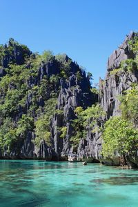Scenic view of sea against clear blue sky