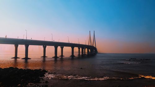 Bridge over sea against clear sky during sunset, mumbai 