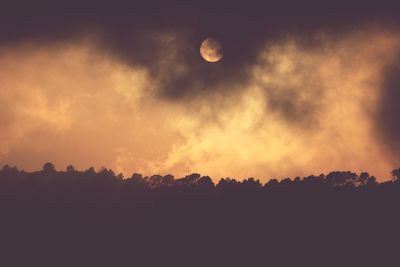 Scenic view of silhouette trees against sky at sunset