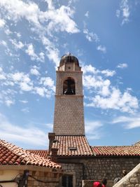 Low angle view of bell tower against sky