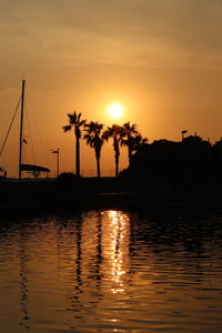 Scenic view of silhouette palm trees against sky during sunset