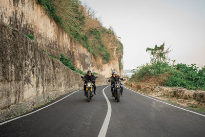 Man riding motorcycle on road