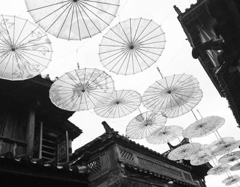 Low angle view of umbrellas for decoration against sky