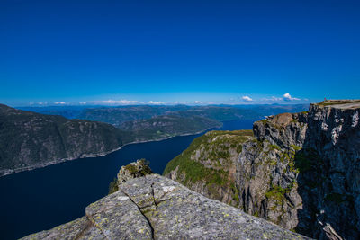 Scenic view of mountains against clear blue sky