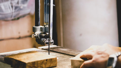 Close-up of hand operating machine in factory