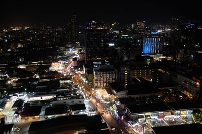 High angle view of illuminated city buildings at night