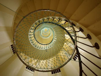 Low angle view of net against spiral staircase in building