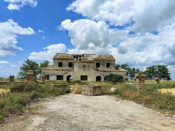 Old building on field against sky