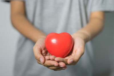 Close-up of woman holding heart shape