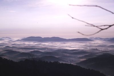 Scenic view of silhouette mountains against sky at sunset