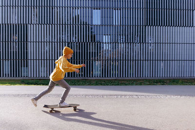 Little boy in casual wear is skating on skateboard. lifestyle concept