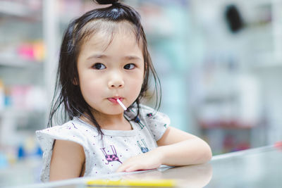 Cute girl with lollipop looking away