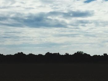 Scenic view of landscape against cloudy sky