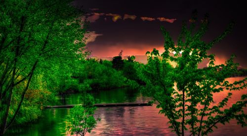 Scenic view of lake against sky at night